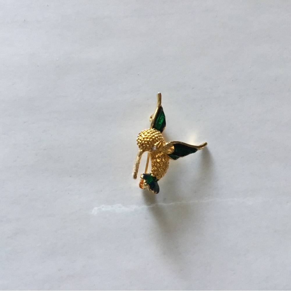 Vintage hummingbird with enamel on the wings and tail, rhinestone eye. Pre-owned